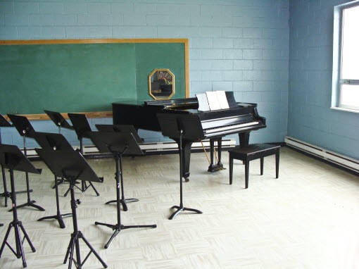 Music classroom with piano and chairs